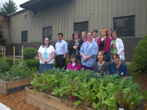 a group of people standing near a garden